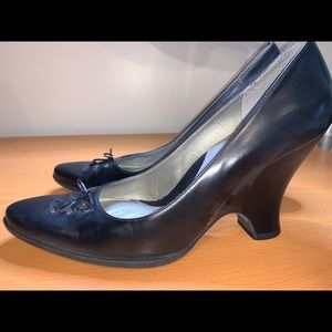 Black curved wedge heel pumps